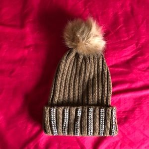 Brown embezzled beanie hat with Pom Pom on top.
